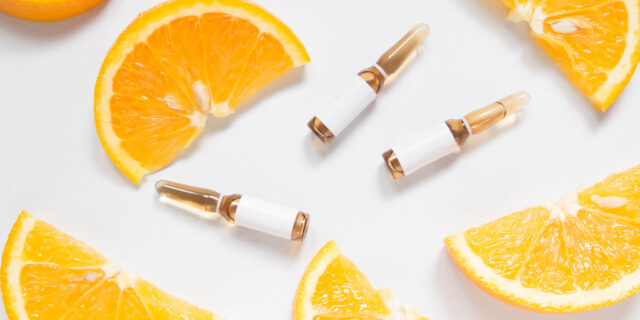 Vitamin,C,Brown,Ampule,For,Injection,With,Fresh,Juicy,Orange